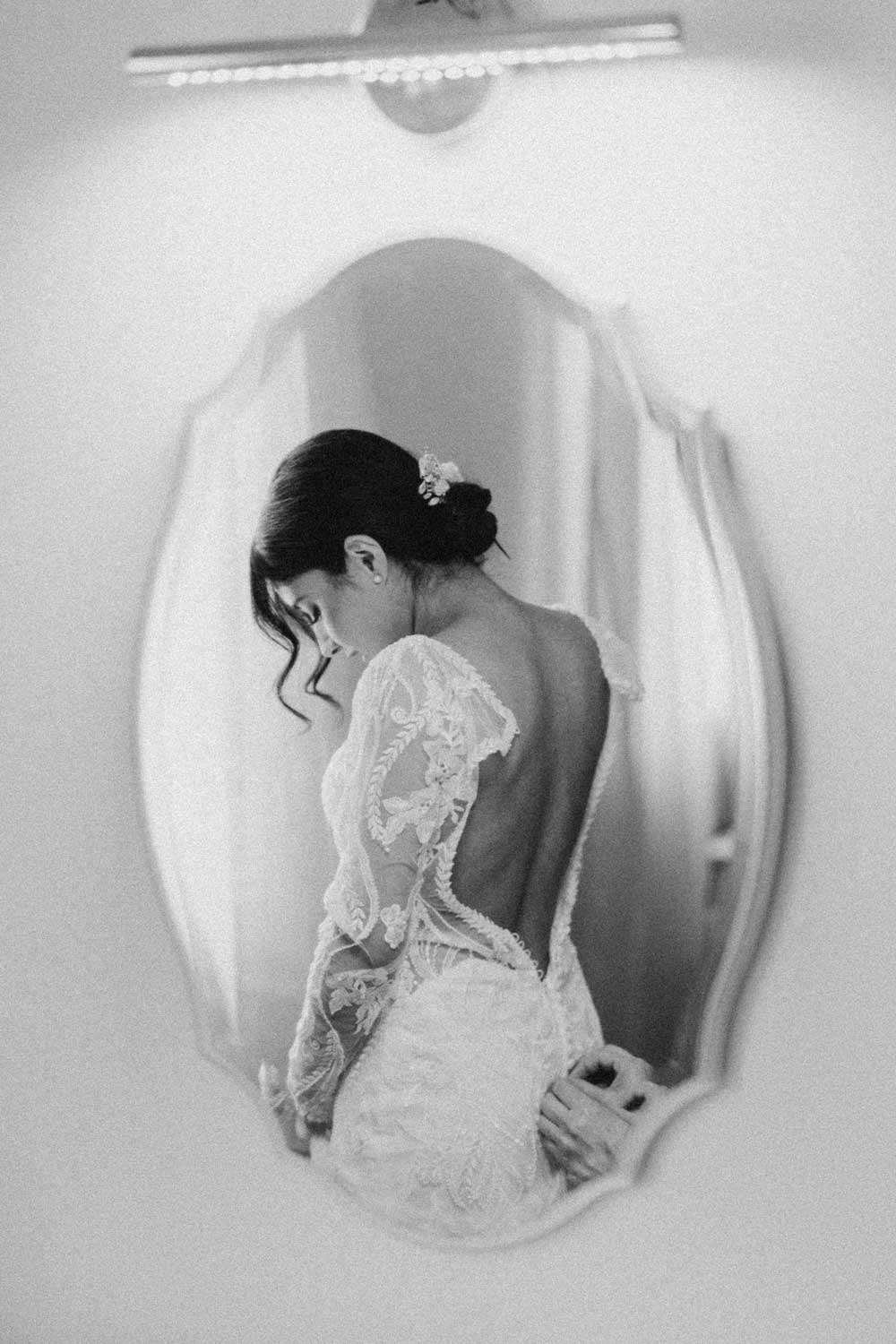 A bride in a wedding dress in a mirror